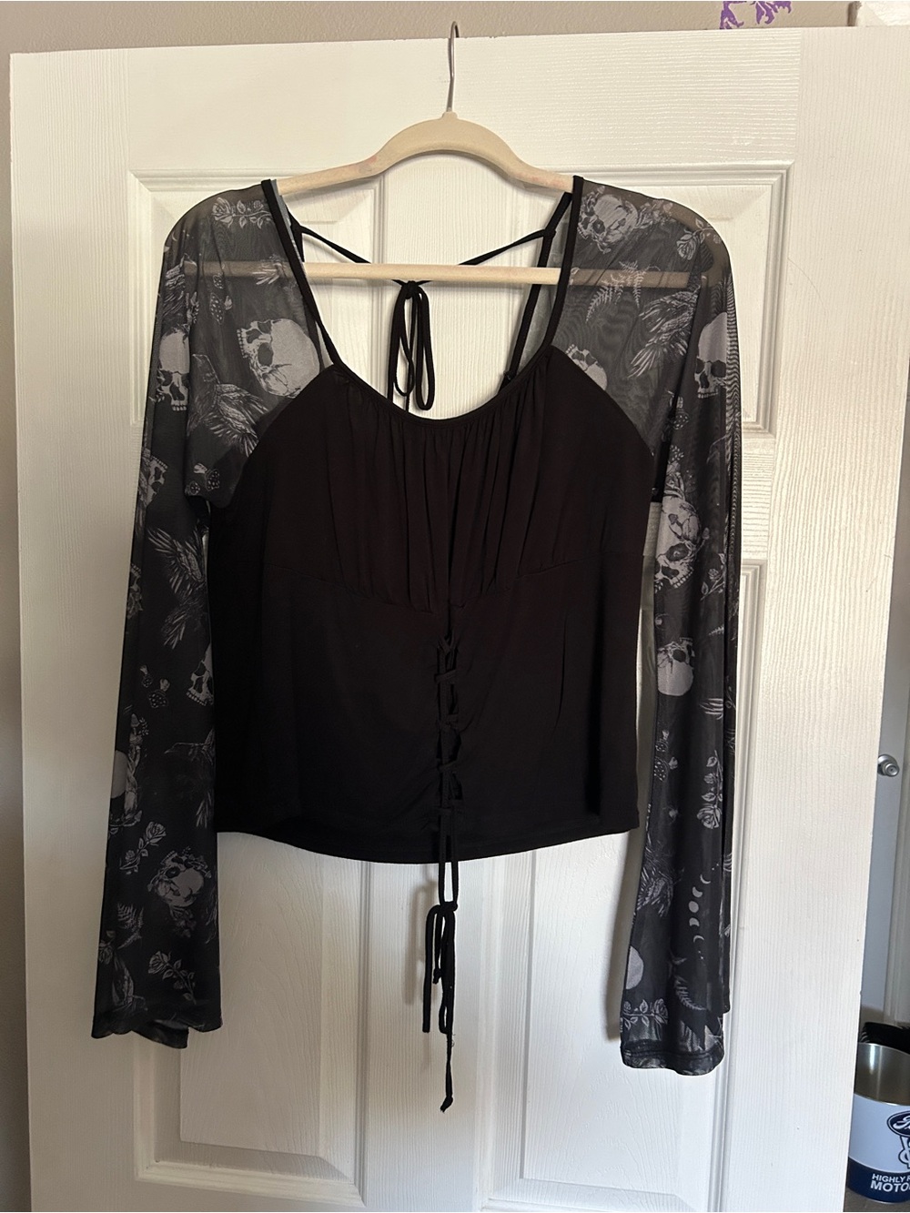 Women’s Black Tie-Front Long Sleeve Top with Sheer Skull-Print Sleeves